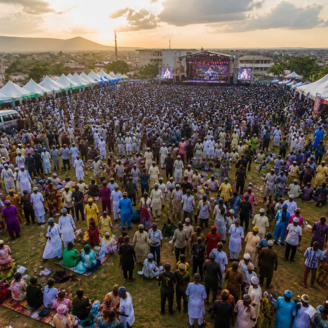 Aerial view of a packed festival ground in Abuja at golden hour